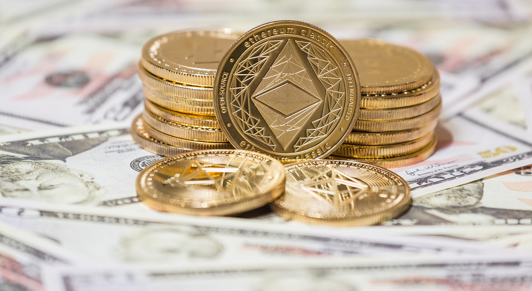 Golden Etherium coin on us dollars close up. Business concept of crypto currency.