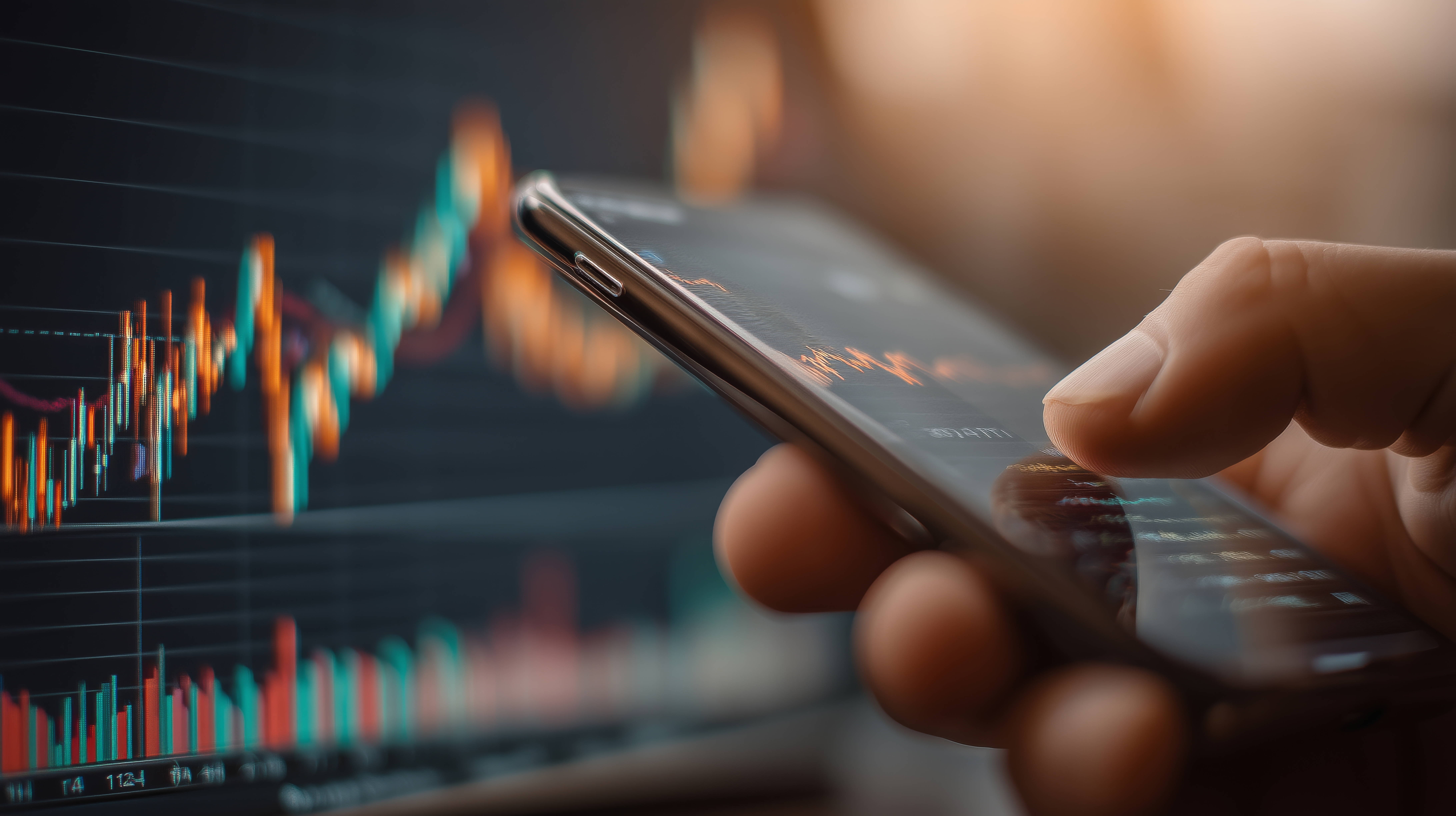 Person using smartphone for stock trading with market graphs
